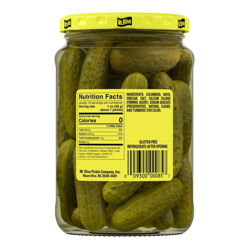 Jar of Mt Olive Kosher Baby Dills with bright yellow lid and label.