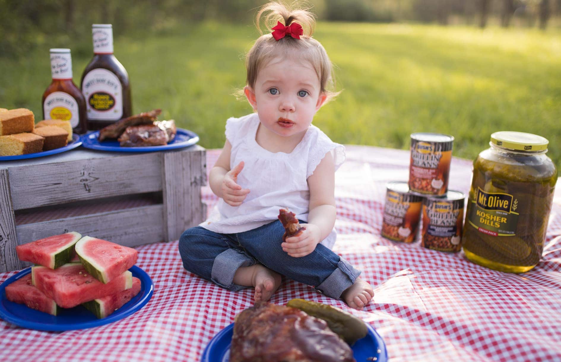 baby at picnic eating ribs