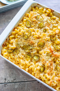 white dish with baked mac and cheese topped with jalapenos