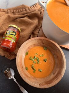 Roasted Red Pepper and Gouda Soup with jar of Mt. Olive Roasted Red Peppers