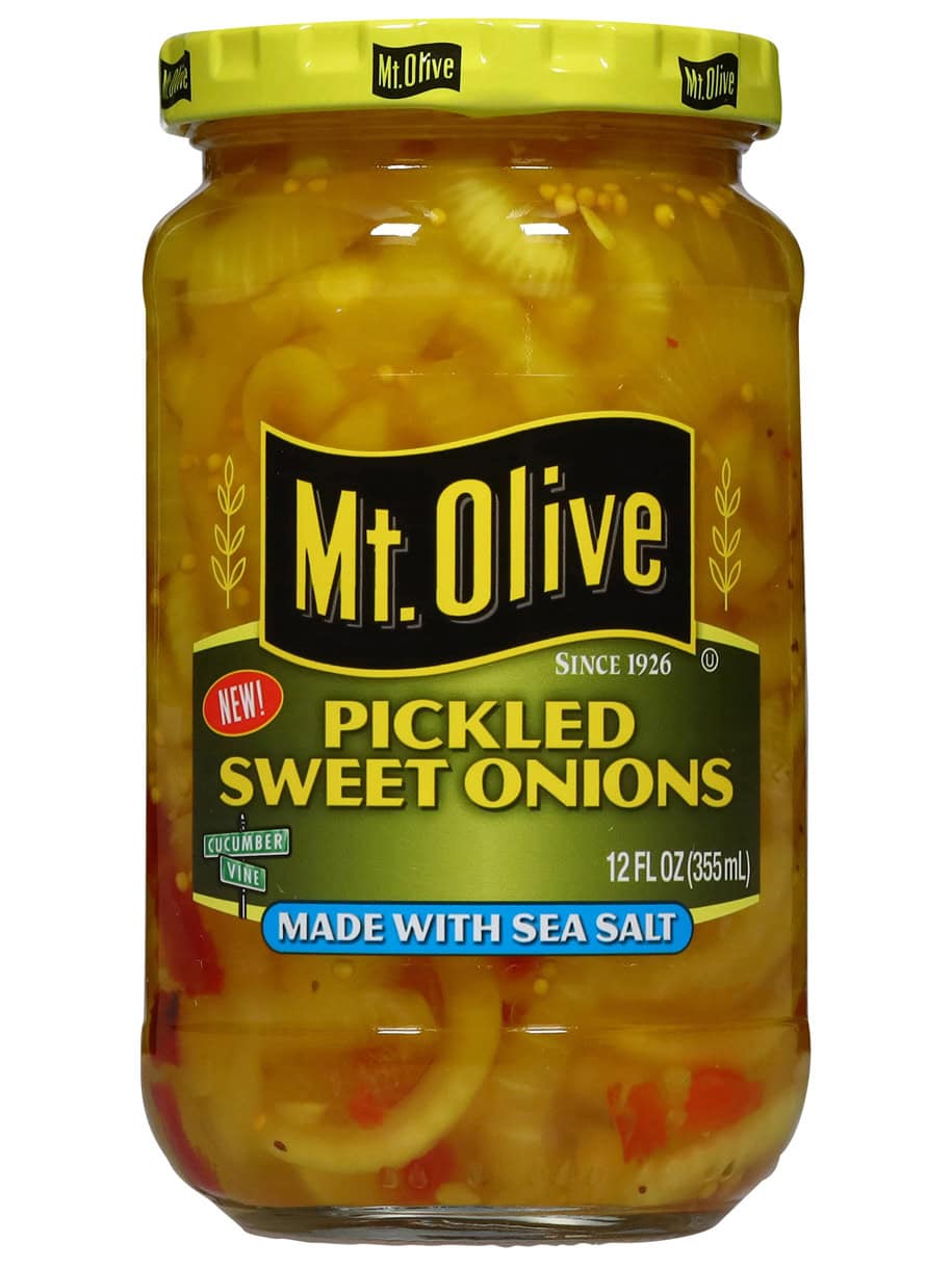 A jar of Mt. Olive Pickled sweet onions sits against a white backdrop.