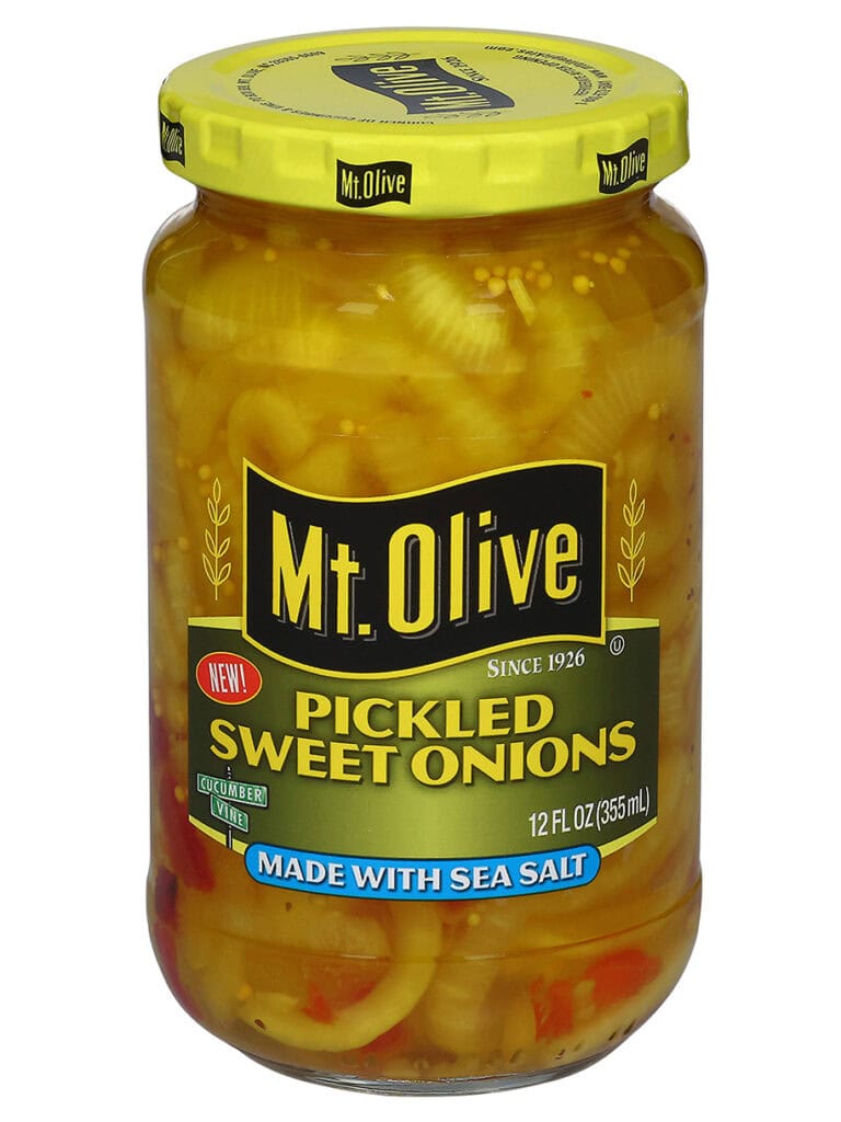 A jar of Mt. Olive Pickled sweet onions sits against a white backdrop.