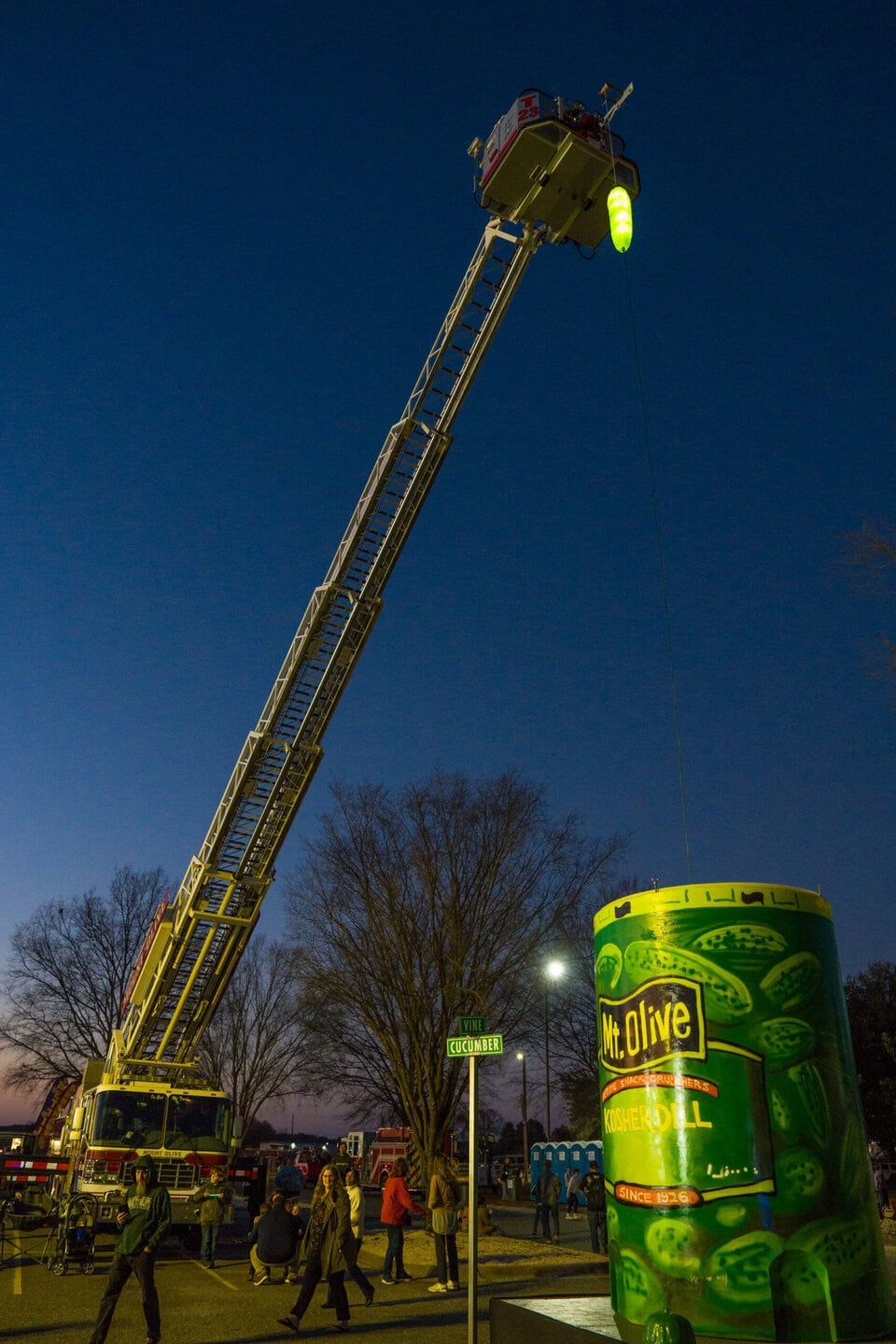 Mt Olive Pickle Drop 2026 from crane with a giant kosher dill jar below the pickle.