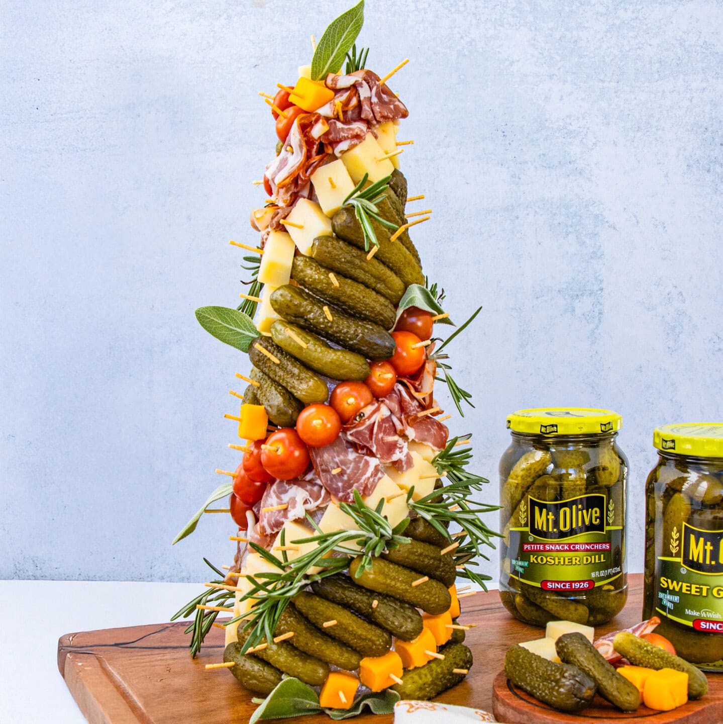 Mt. Olive Sweet Gherkins & Kosher Dill Petite Snack Crunchers with cheese, salami, & tomatoes on a 3D charcuterie tree.