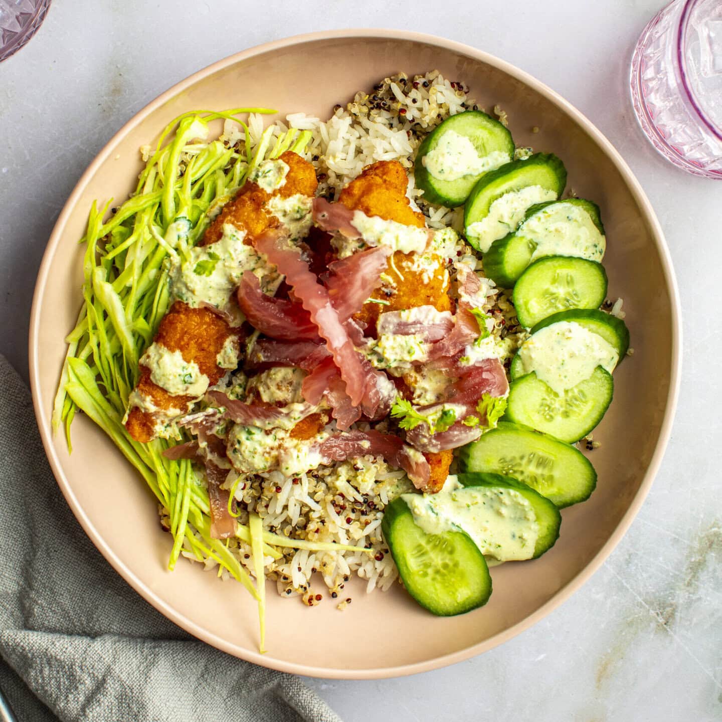 Chicken tikka masala bowl with quinoa, pickled onions, and cucumbers
