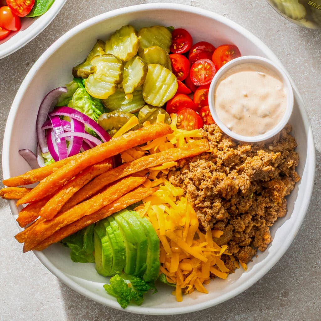 A Ground Turkey Cheeseburger Salad with Pickles & Burger Sauce.