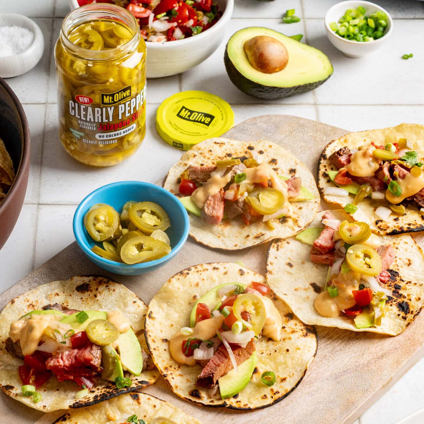 A serving platter of jalapeno steak tacos with Mount Olive Clearly Peppers.