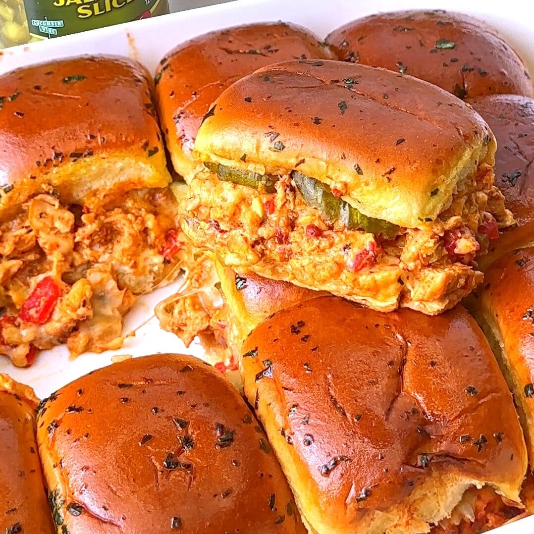 Delicious chipotle chicken sliders with melted cheese and herbs.