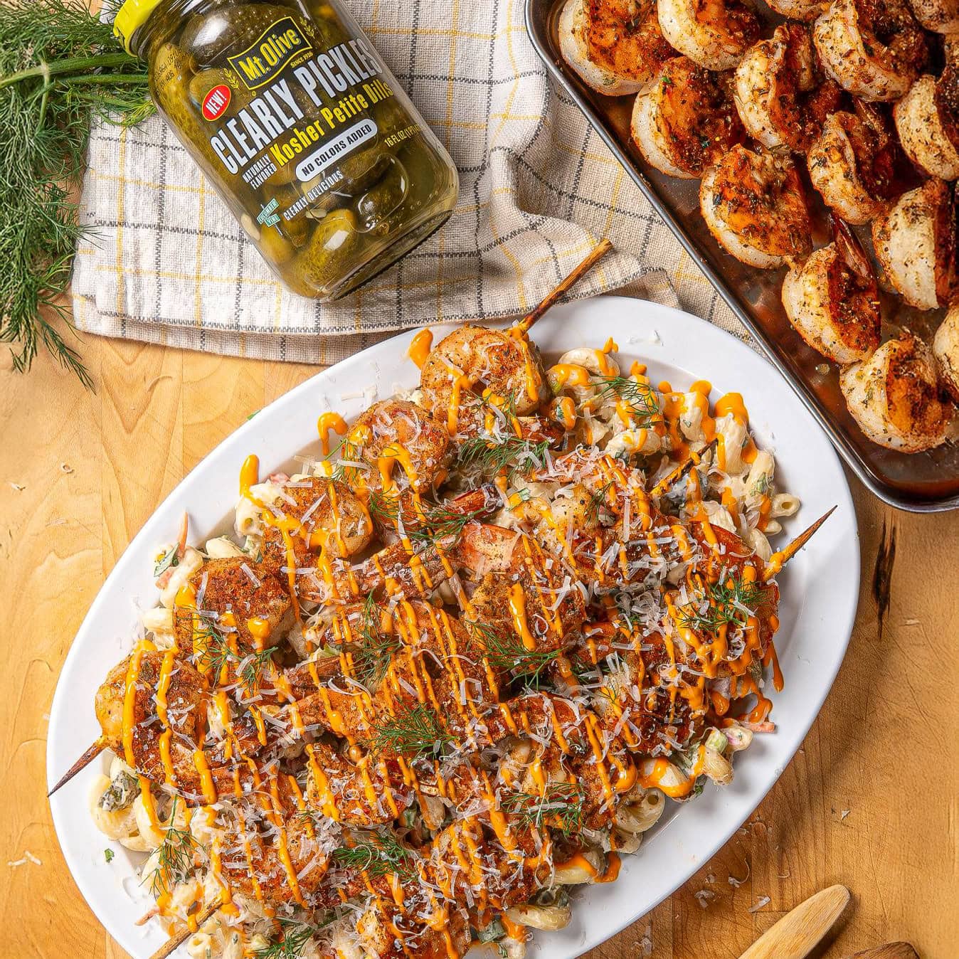 shrimp skewers over creamy pasta salad