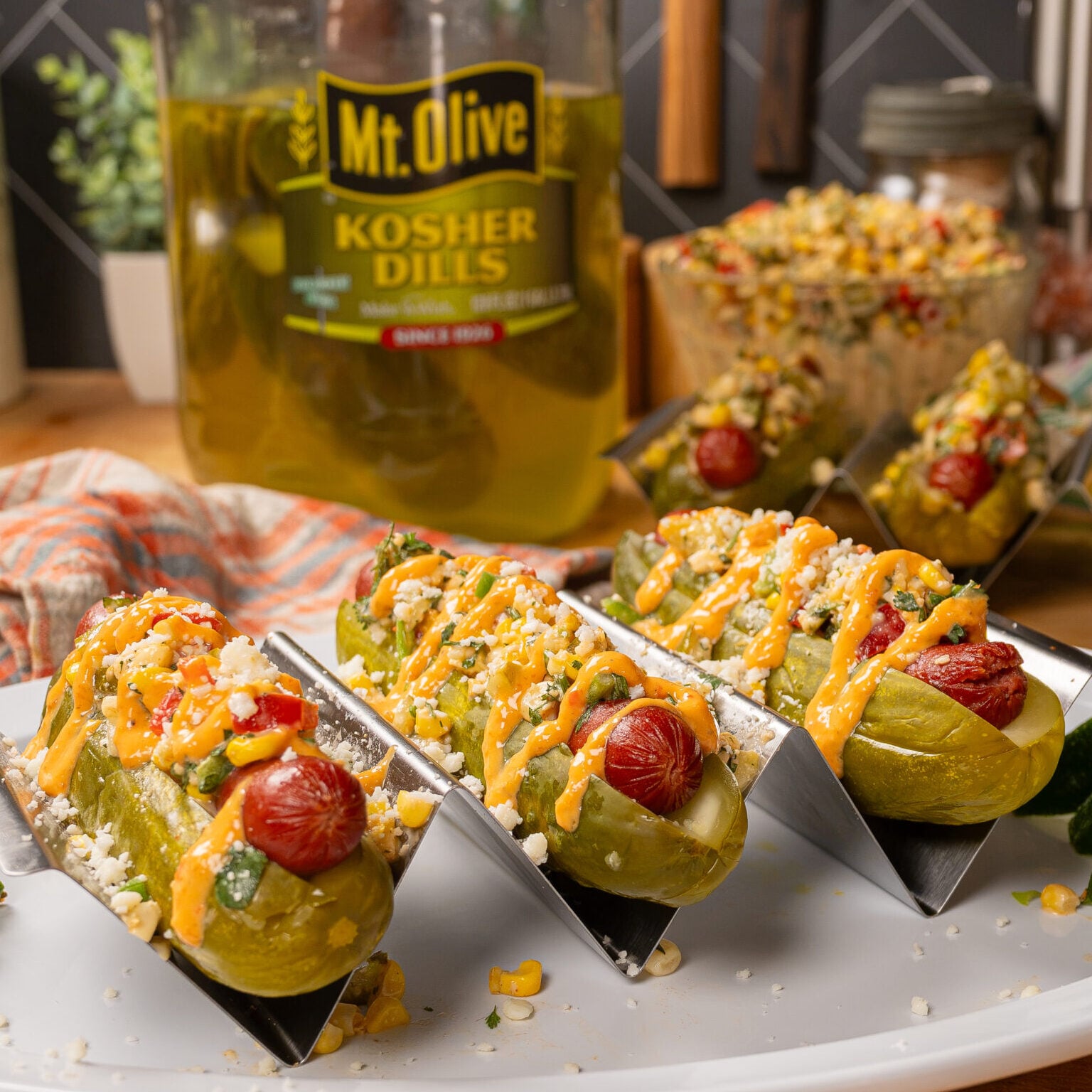 Fresh stuffed pickles with peppers and cheese on a white plate.