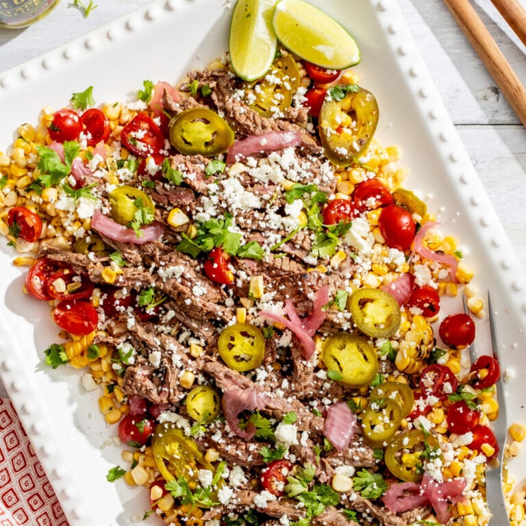Healthy Mediterranean quinoa salad with pickles, cherry tomatoes, and feta cheese.