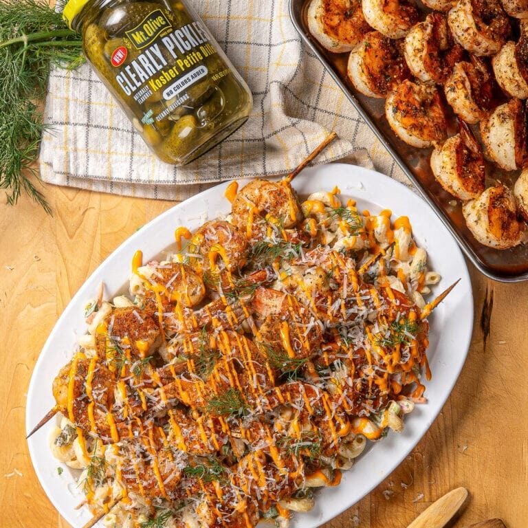 shrimp skewers over creamy pasta salad